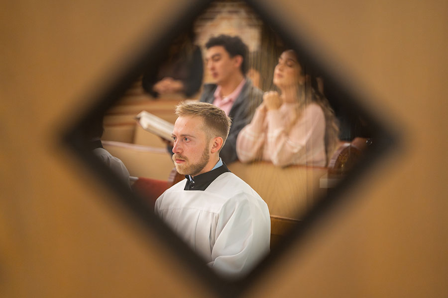 A diamond frames an altar server and a couple praying during the Young Adult Mass.